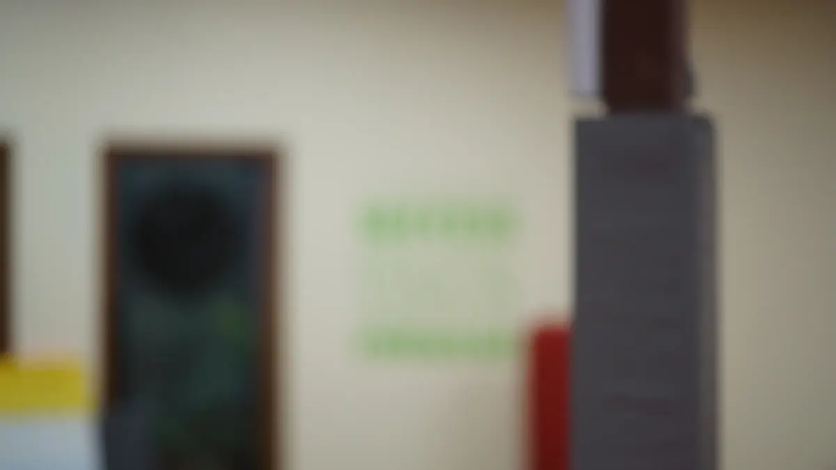 The academy's entrance and wall lettering, softly out of focus