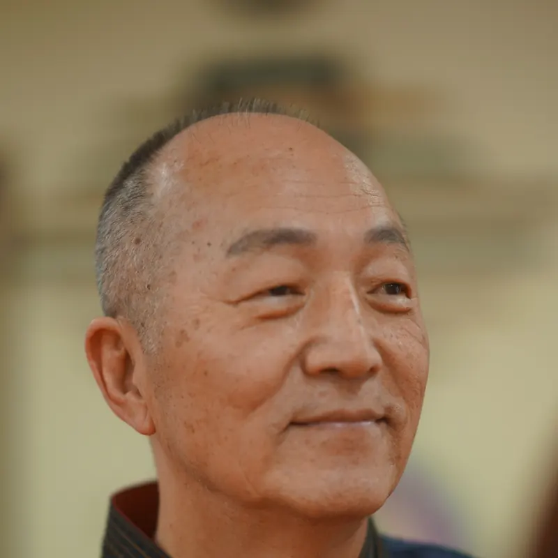 Close portrait of Grand Master Won Kuk Kim with a gentle smile