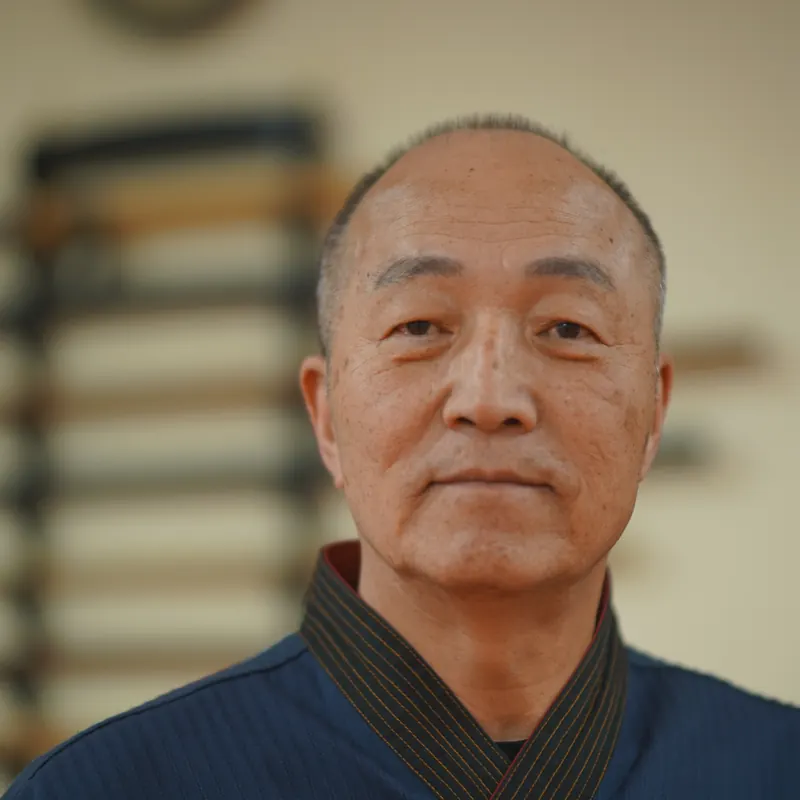 Front portrait of Grand Master Won Kuk Kim in his navy dobok