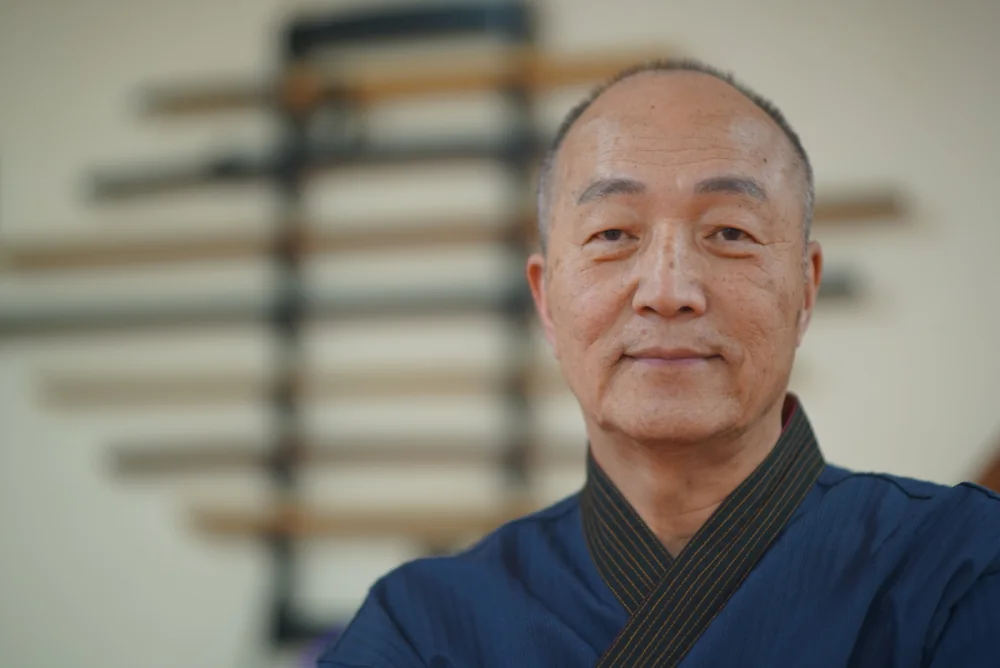 Grand Master Won Kuk Kim, smiling.